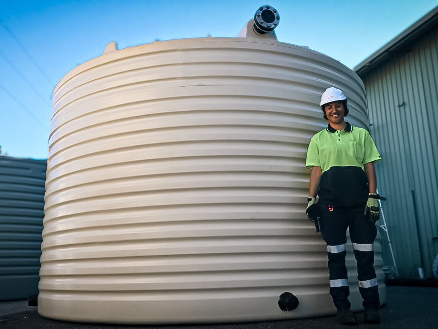 Zoe Standing Next To A Process Water Tank For A Mine Site